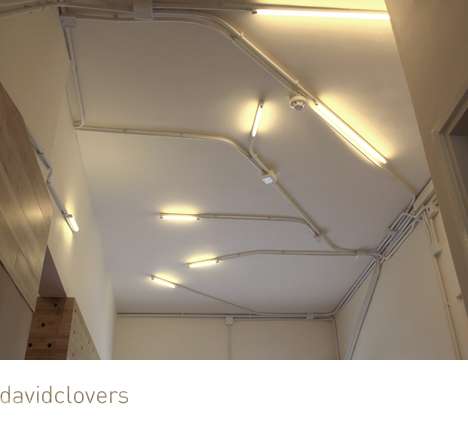Photograph of exposed fluorescent “climbers” and custom fixures in children’s bathroom Morningstar Preschool
